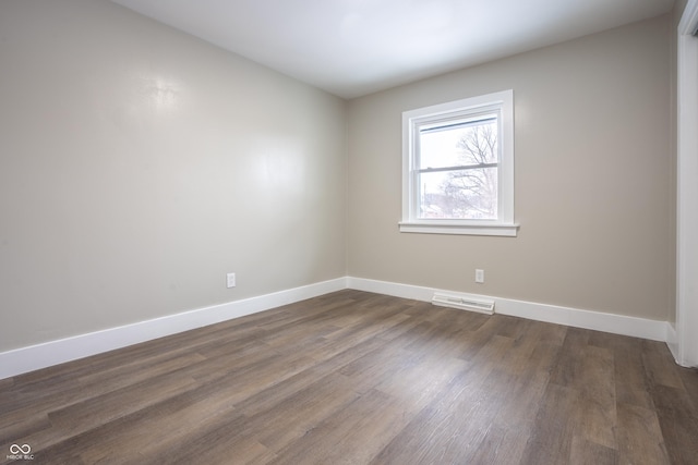 empty room with dark hardwood / wood-style floors