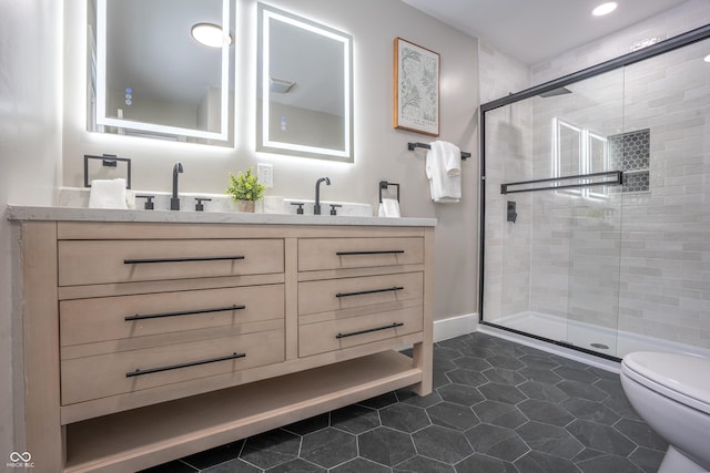 bathroom featuring a shower with door, tile patterned floors, vanity, and toilet