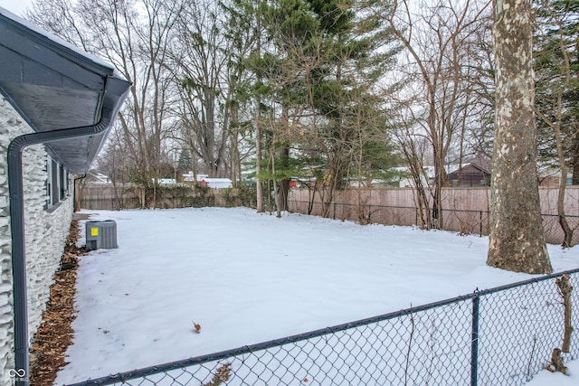 yard covered in snow with central AC unit