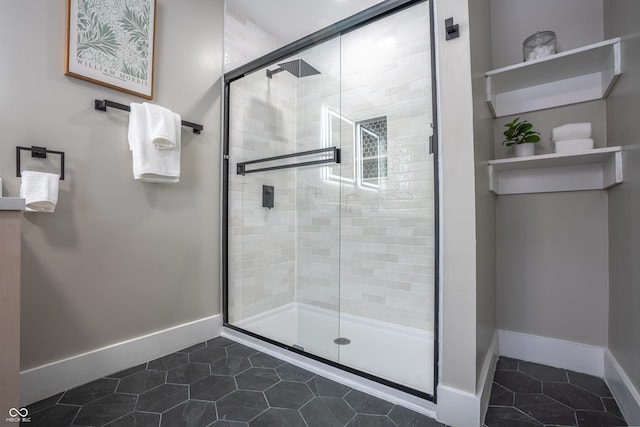 bathroom featuring a shower with shower door and tile patterned flooring