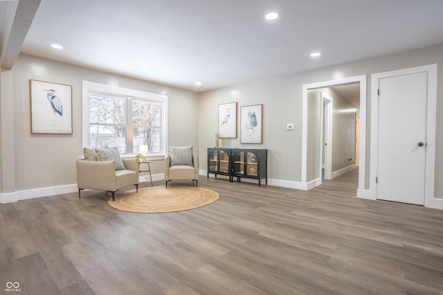 sitting room with hardwood / wood-style flooring