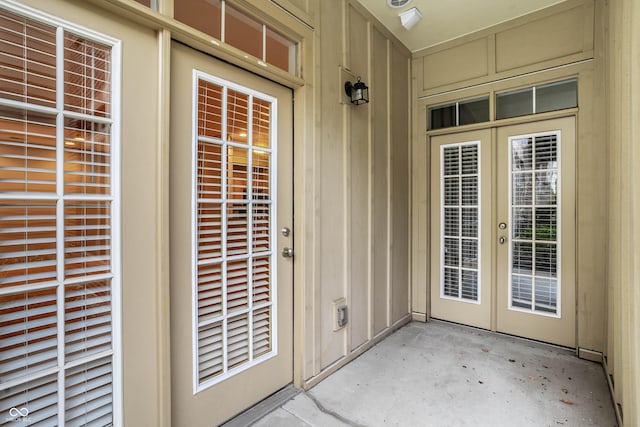 property entrance featuring a patio and french doors