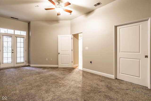 empty room featuring french doors, ceiling fan, and carpet