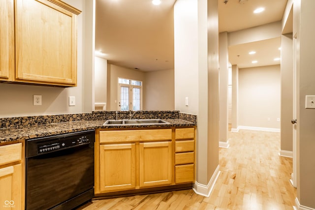 kitchen with sink, light wood-type flooring, light brown cabinets, dark stone countertops, and dishwasher