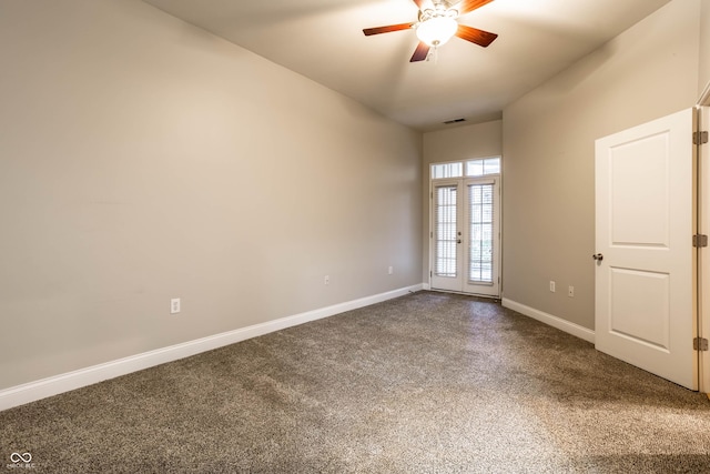 unfurnished room with ceiling fan and carpet