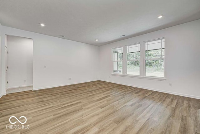 spare room with light hardwood / wood-style floors