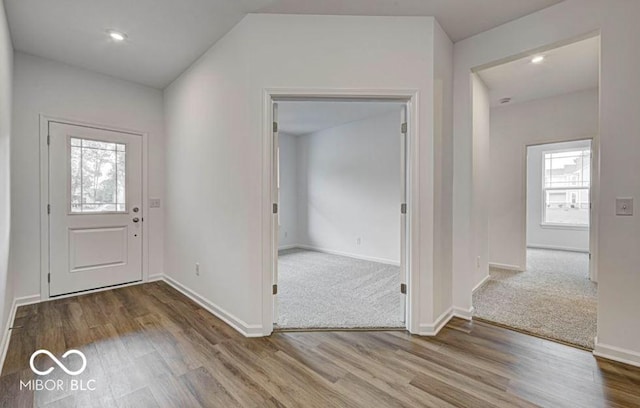 entrance foyer featuring lofted ceiling and hardwood / wood-style flooring