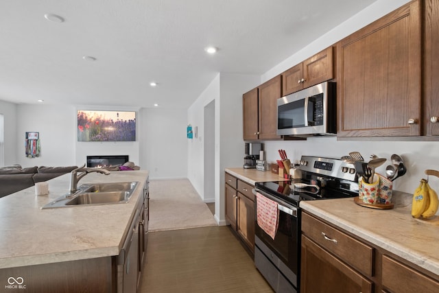 kitchen featuring a kitchen island with sink, appliances with stainless steel finishes, and sink