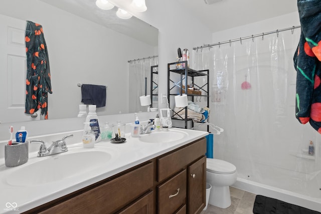 bathroom featuring toilet, vanity, a shower with curtain, and tile patterned floors