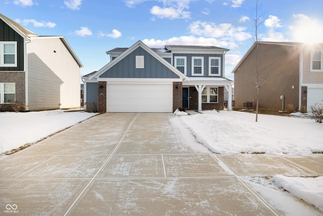 view of front of home with a garage and central air condition unit