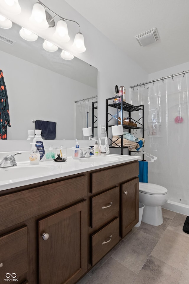 bathroom featuring toilet, walk in shower, and vanity