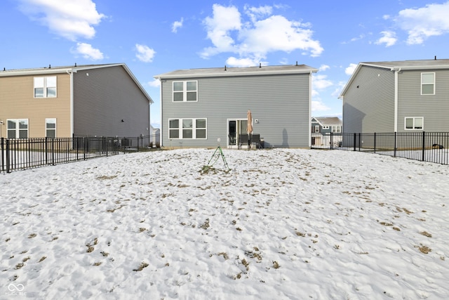 view of snow covered back of property