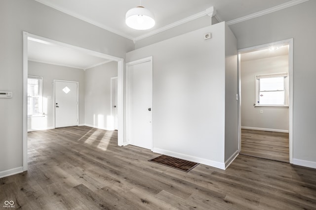 foyer featuring crown molding and hardwood / wood-style flooring