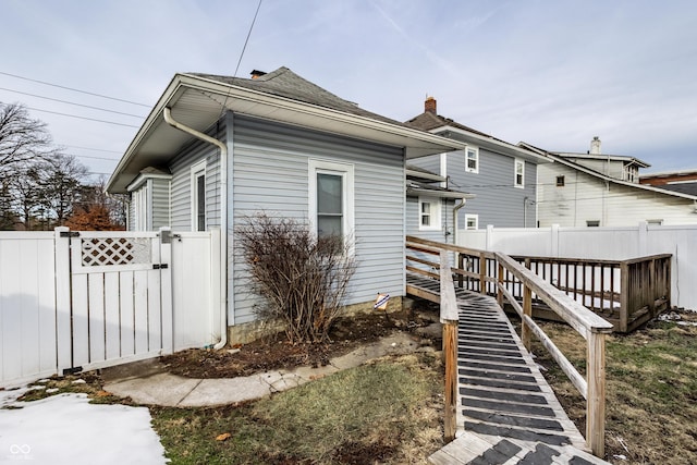 view of property exterior featuring a wooden deck