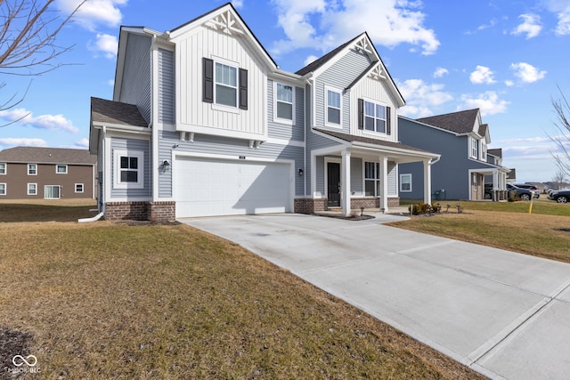 view of front of house with a garage, a front yard, and covered porch