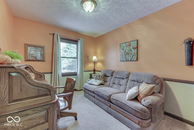 carpeted home office featuring a textured ceiling