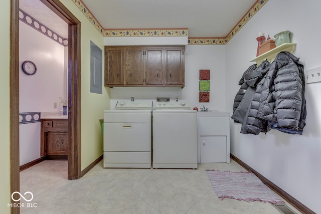 laundry room featuring cabinets, electric panel, and washer and dryer