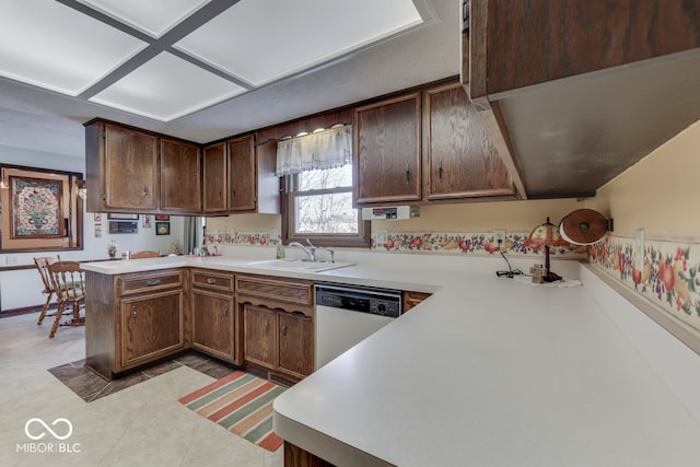 kitchen featuring sink, dark brown cabinetry, stainless steel dishwasher, and kitchen peninsula