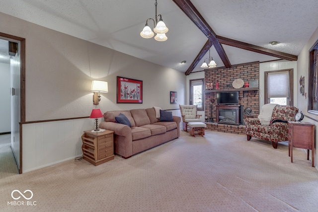 carpeted living room featuring lofted ceiling with beams, a textured ceiling, and a brick fireplace