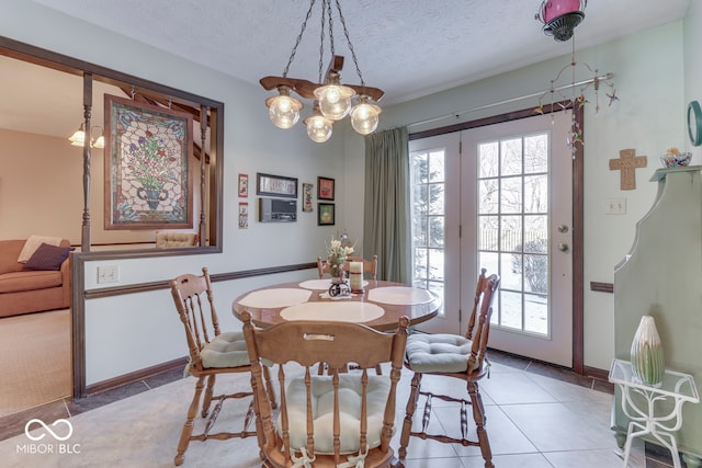 dining room with a textured ceiling and tile patterned flooring