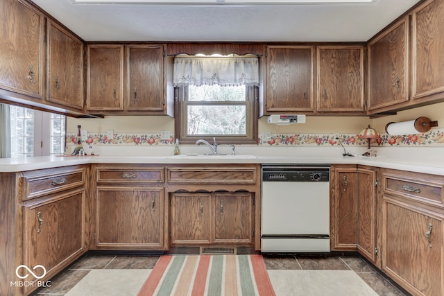 kitchen featuring white dishwasher and sink