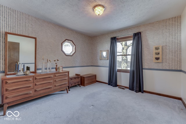 interior space featuring light carpet and a textured ceiling