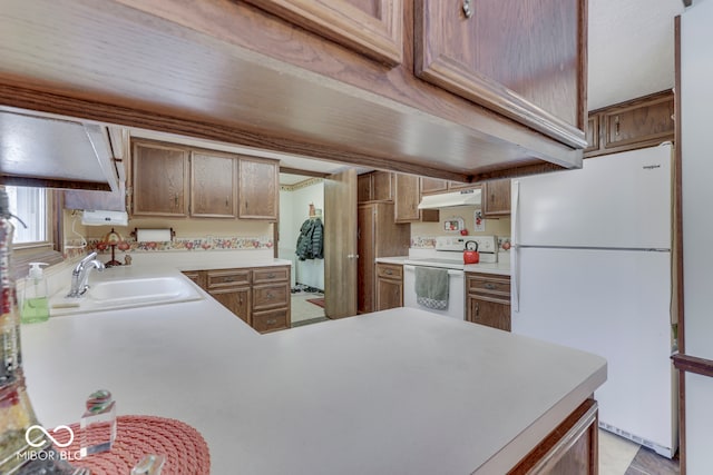 kitchen featuring sink and white appliances