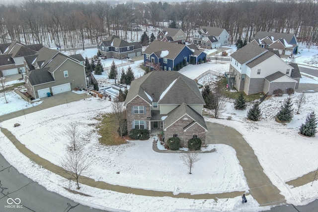 snowy aerial view featuring a residential view