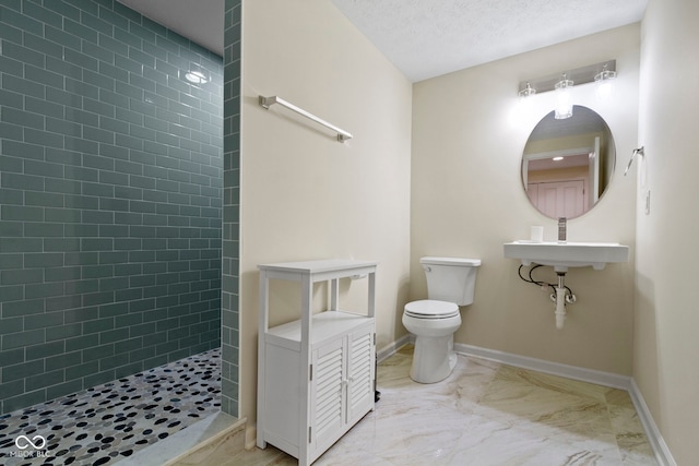 full bath with marble finish floor, tiled shower, baseboards, and toilet