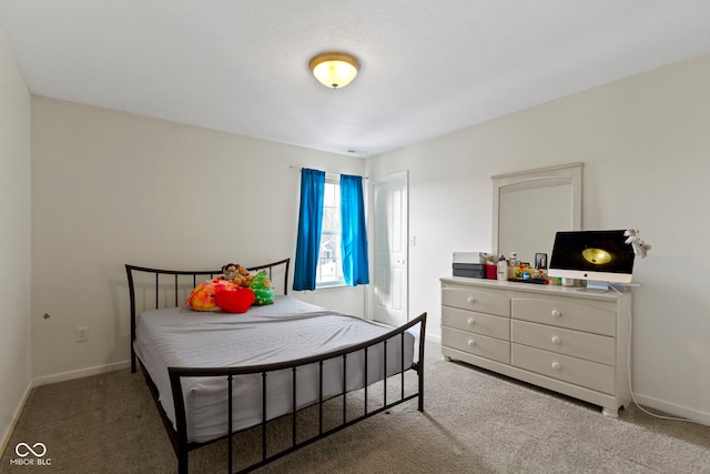 carpeted bedroom featuring baseboards