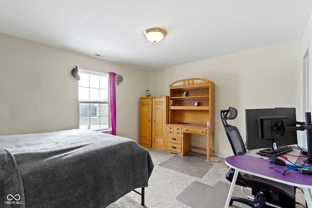 bedroom with light carpet and visible vents