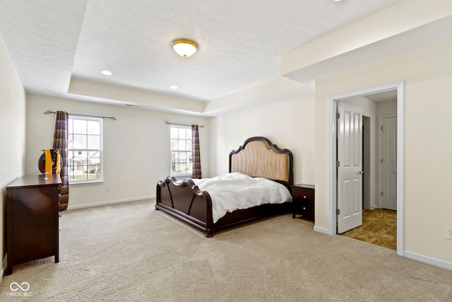 bedroom with baseboards, carpet, a tray ceiling, a textured ceiling, and recessed lighting