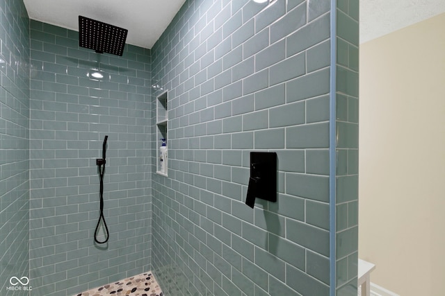 bathroom with a tile shower