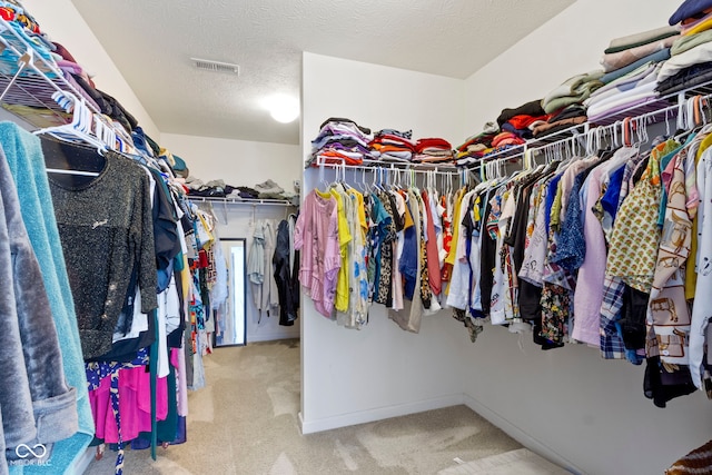 spacious closet featuring carpet and visible vents