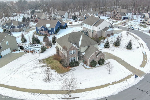 snowy aerial view featuring a residential view