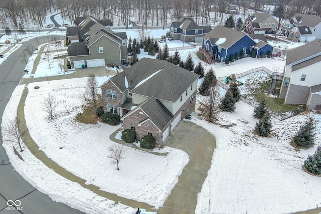 snowy aerial view with a residential view