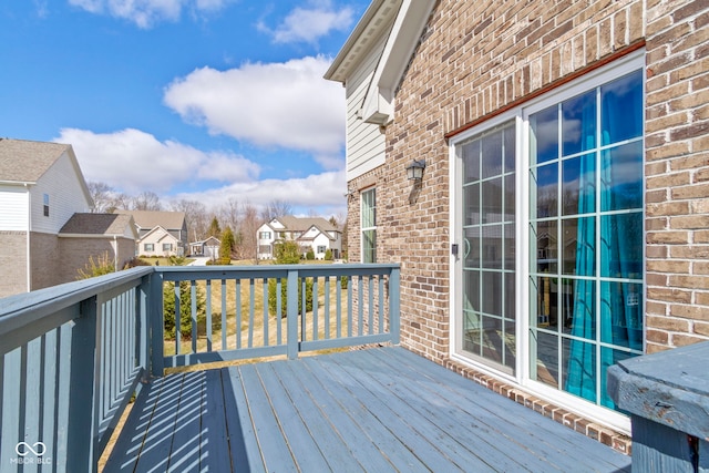 wooden terrace featuring a residential view