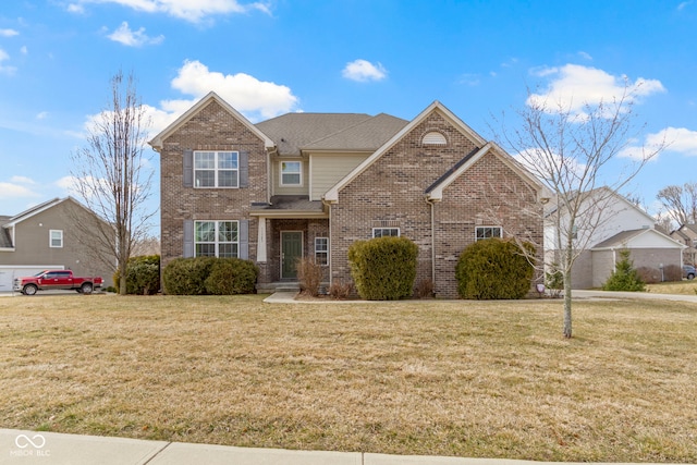 view of front of house featuring a shingled roof, a front yard, and brick siding