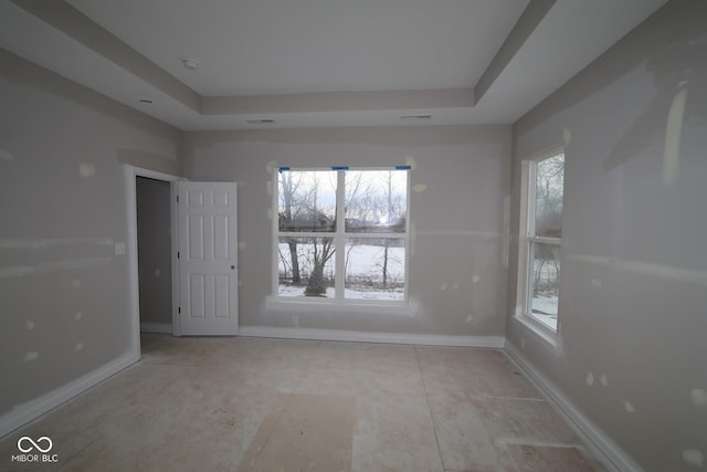 empty room featuring a tray ceiling