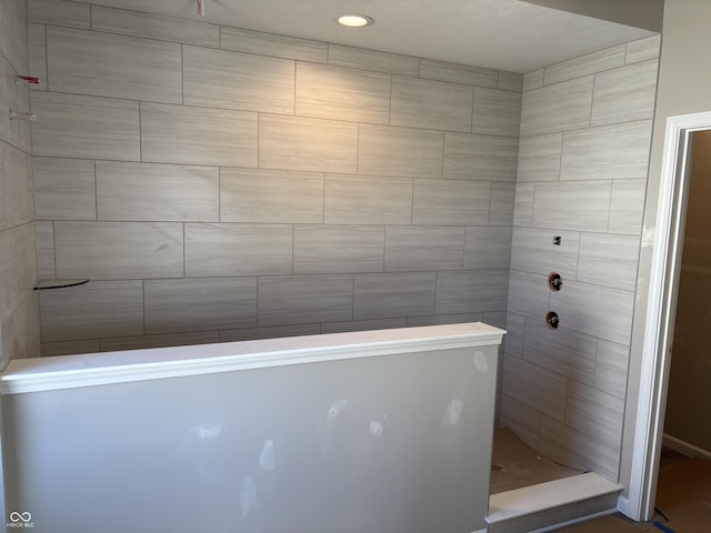 bathroom with tiled shower