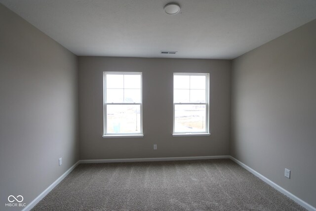 unfurnished room featuring carpet