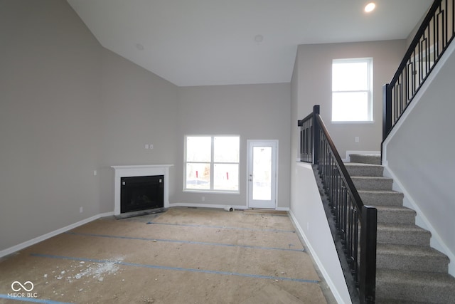 unfurnished living room featuring a high ceiling