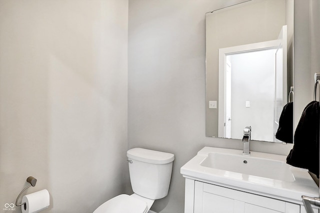 bathroom featuring toilet and vanity