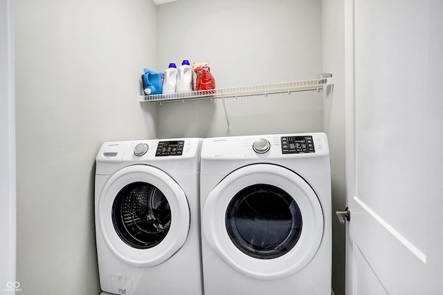 clothes washing area featuring independent washer and dryer