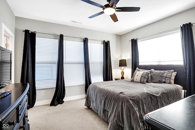 bedroom featuring light colored carpet and ceiling fan