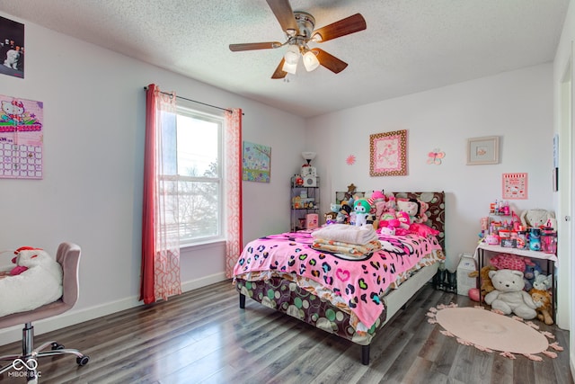 bedroom featuring dark hardwood / wood-style flooring, a textured ceiling, and ceiling fan