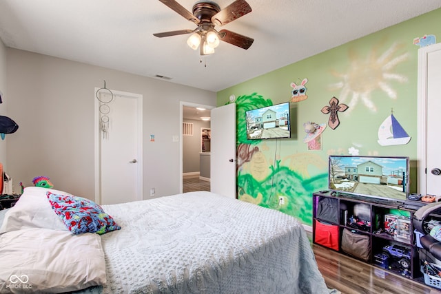 bedroom with hardwood / wood-style floors and ceiling fan