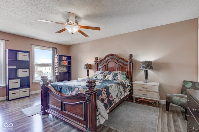 bedroom featuring hardwood / wood-style floors, a textured ceiling, and ceiling fan