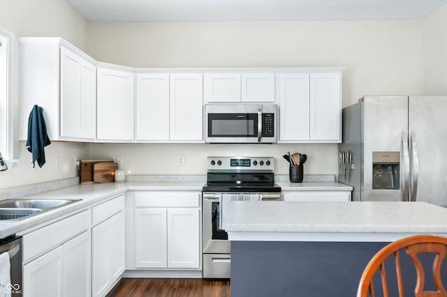 kitchen featuring sink, stainless steel appliances, and white cabinets