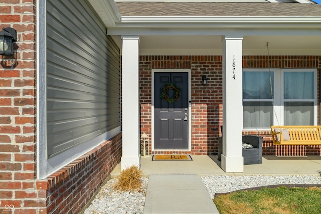 view of exterior entry with covered porch